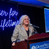 Susan Proctor talking to students with countdown in the background